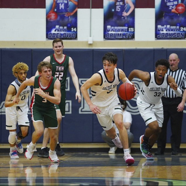 Drew Calderon (3) dribbles the ball down court, maneuvering around his opponents with the help of his teammates, Nathaniel Murphy (0) and  Markel James (32).