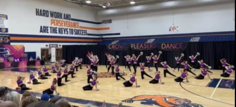 The Reveliers perform their team pom at their first contest. 