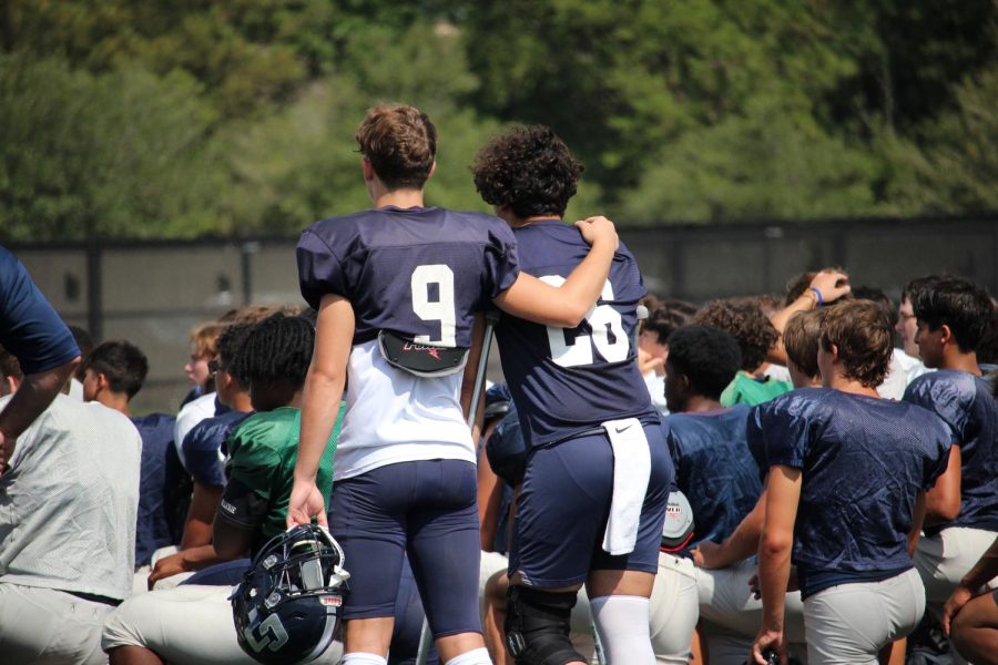 Football players huddling at the pre season scrimmage.